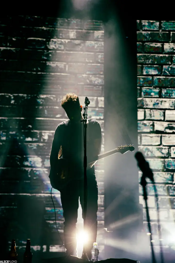Echoes on stage in front of a white brick wall